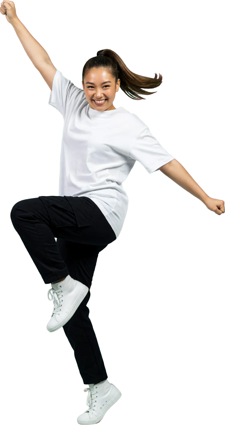 A dancer in a white t-shirt and black cargo trousers mid-move, one knee up and one fist in the air