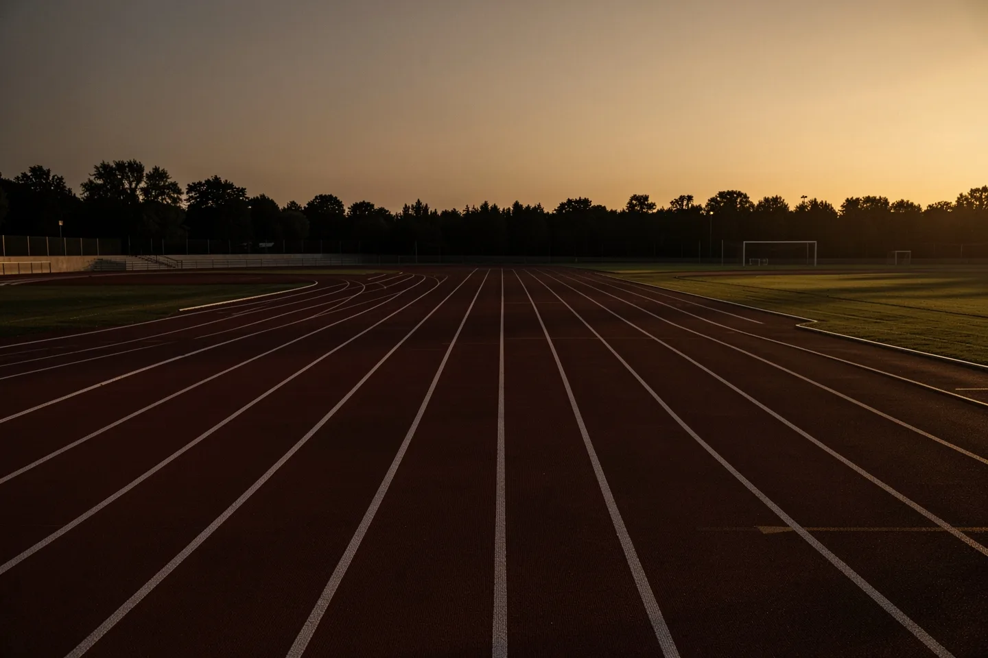 An empty running track at dusk
