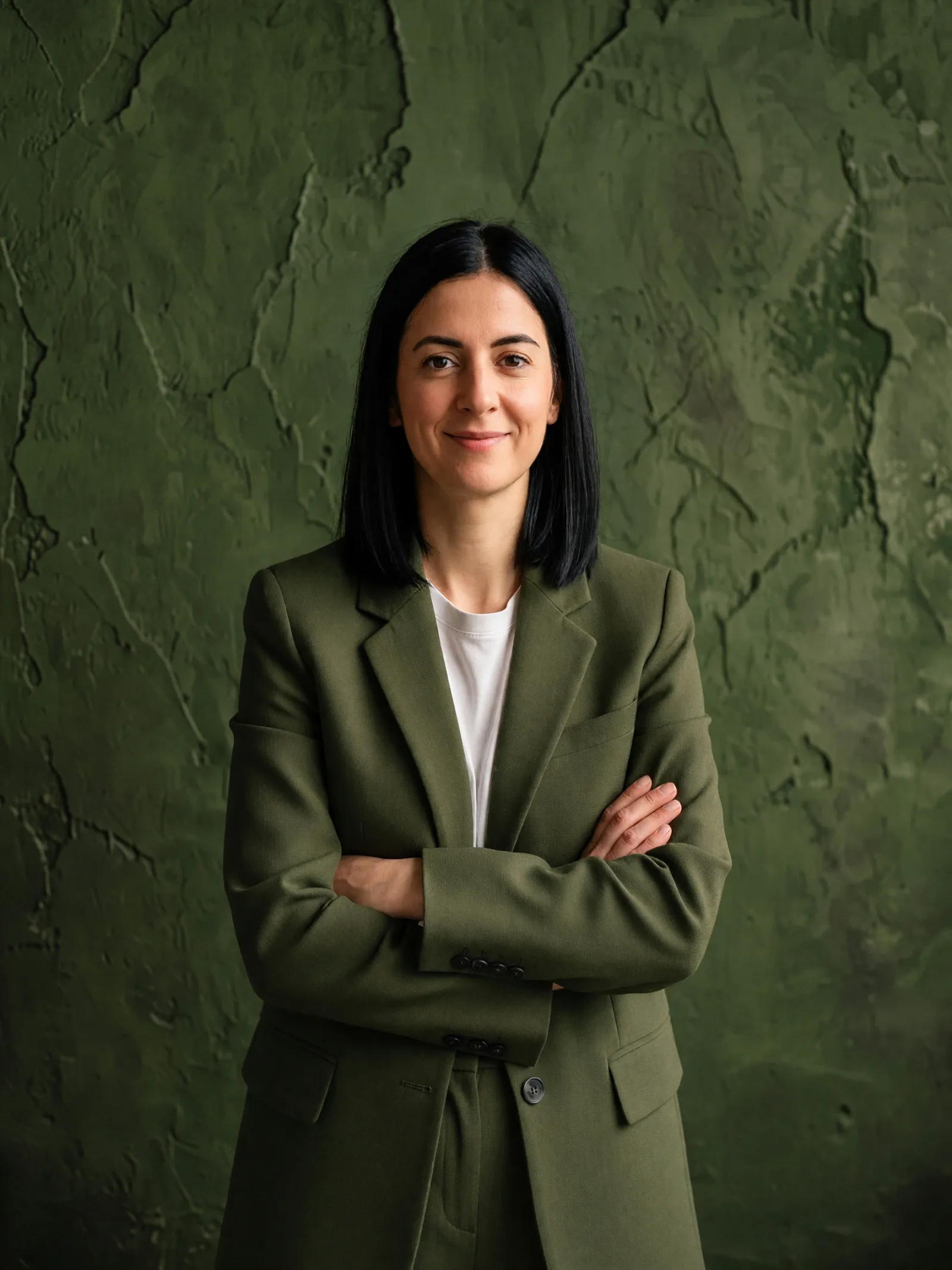 Mira Kovač against an olive green wall