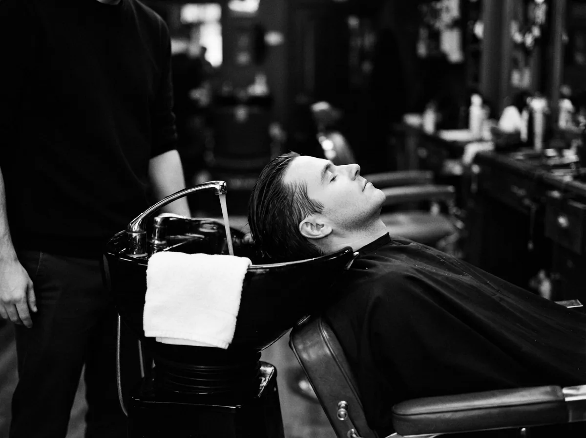 A client leaning back at the wash basin