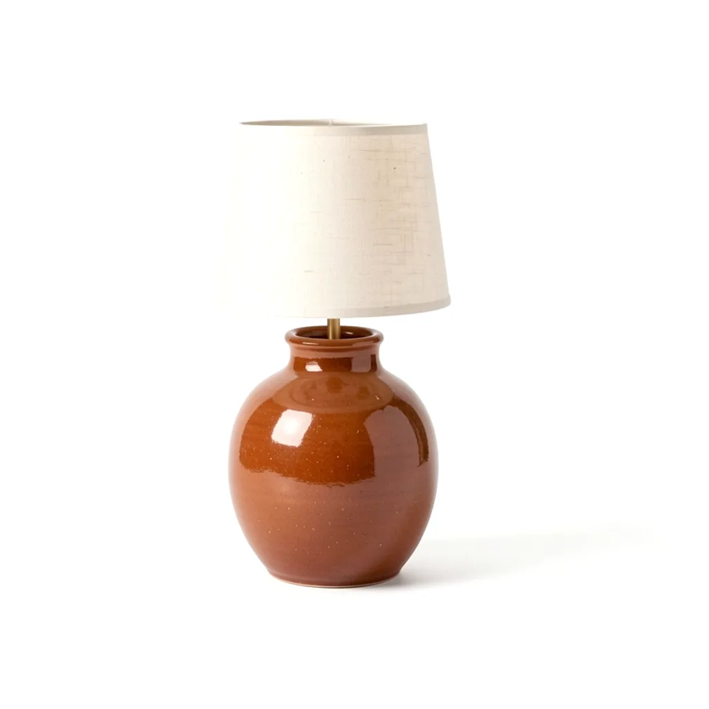 The stoneware table lamp in a rust glaze