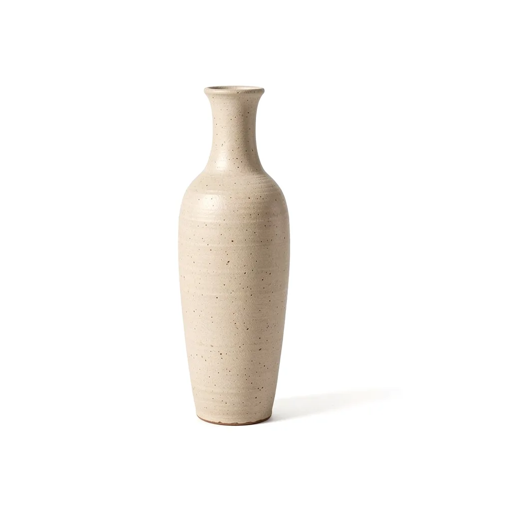 A tall stoneware vase in a speckled oatmeal glaze